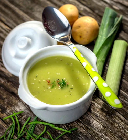 Homemade creamy leek soup on wooden background jpeg
