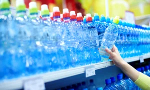 9331615   close up of female choosing good mineral water in a shop jpeg