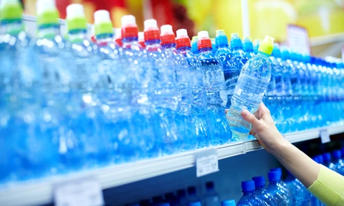 9331615   close up of female choosing good mineral water in a shop jpeg