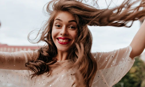 happy woman stylish outfit smiles widely poses balcony cheerful girl white dress with sparkles takes selfie (1) jpg