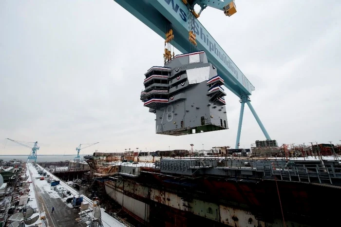 Description: NEWPORT NEWS, Va. (Jan. 26, 2013) Huntington Ingalls Industries celebrated significant progress today as the 555-metric ton island was lowered onto the nuclear-powered aircraft carrier Gerald R. Ford (CVN 78) at the company's Newport News Shipbuilding (NNS) division. The 60-foot long, 30-foot wide island was the 452nd lift of the nearly 500 total lifts needed to complete the aircraft carrier. (U.S. Navy photo courtesy Huntington Ingalls Industries/Released)