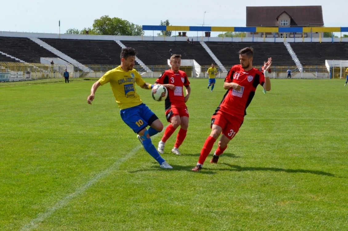 Sălăgeanu (echipament galben albastru) nu a mai repetat  evoluţille bune din ultima perioadă, atacantul sătmărean fiind anihilat de apărătorii reşiţeni. FOTO - portalsm.ro