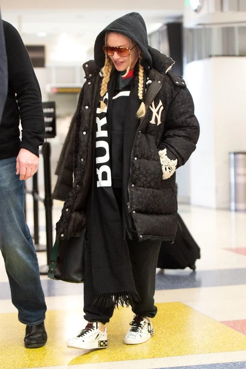 Madonna cu geaca uriaşă şi codiţe de fetiţe pe aeroport