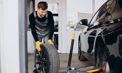 car mechanic changing wheels car jpg