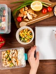 hands writing notebook with casseroles ad food jpg