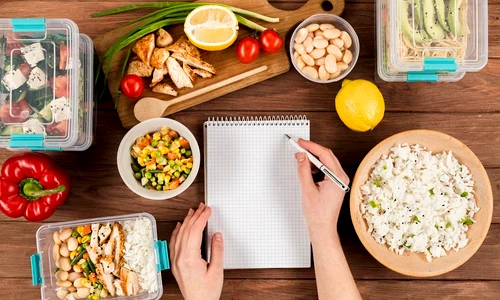 hands writing notebook with casseroles ad food jpg