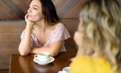 dreamy young woman sitting cafe table looking window jpg