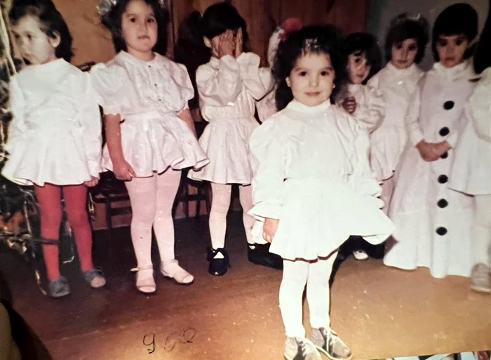 Cântăreața Minelli în copilărie, la o serbare, îmbrăcată într-o rochiță albă 
