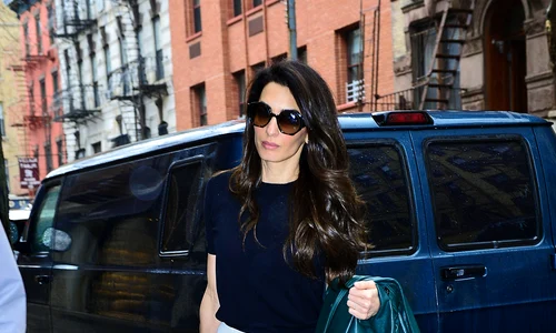 Amal Clooney looks striking in a blue top and white skirt as she arrives back home in NYC jpeg