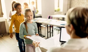 elementary students taking their test results from teacher classroom jpg