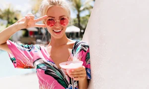 portrait blissful blonde woman posing with peace sign drinking cocktail happy tanned caucasian girl bright dress having fun summer resort jpg