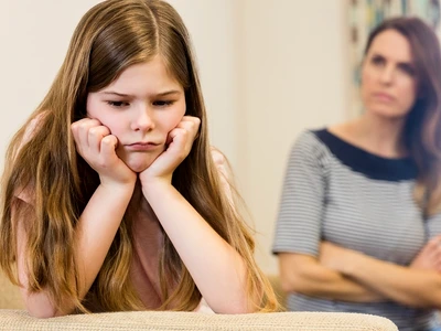 daughter sitting upset with her mother living room jpg