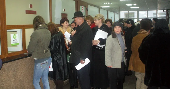 Zeci de oameni îşi aşteaptă rândul la ghişeele Casei Judeţene de Pensii Alba