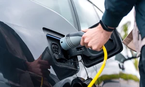 man plugging charger into electric Copy jpg