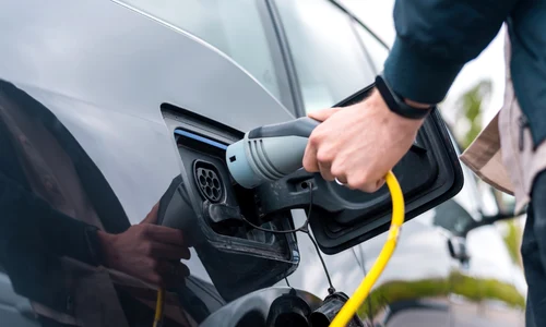 man plugging charger into electric    Copy jpg