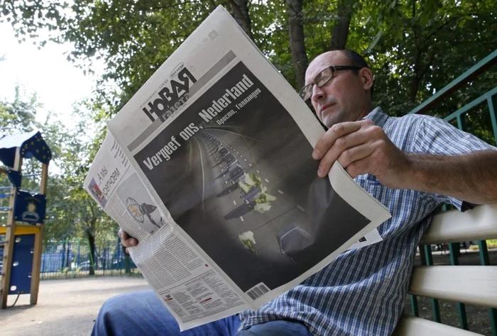Un barbat citind Noavaia Gazeta FOTO EPA-EFE