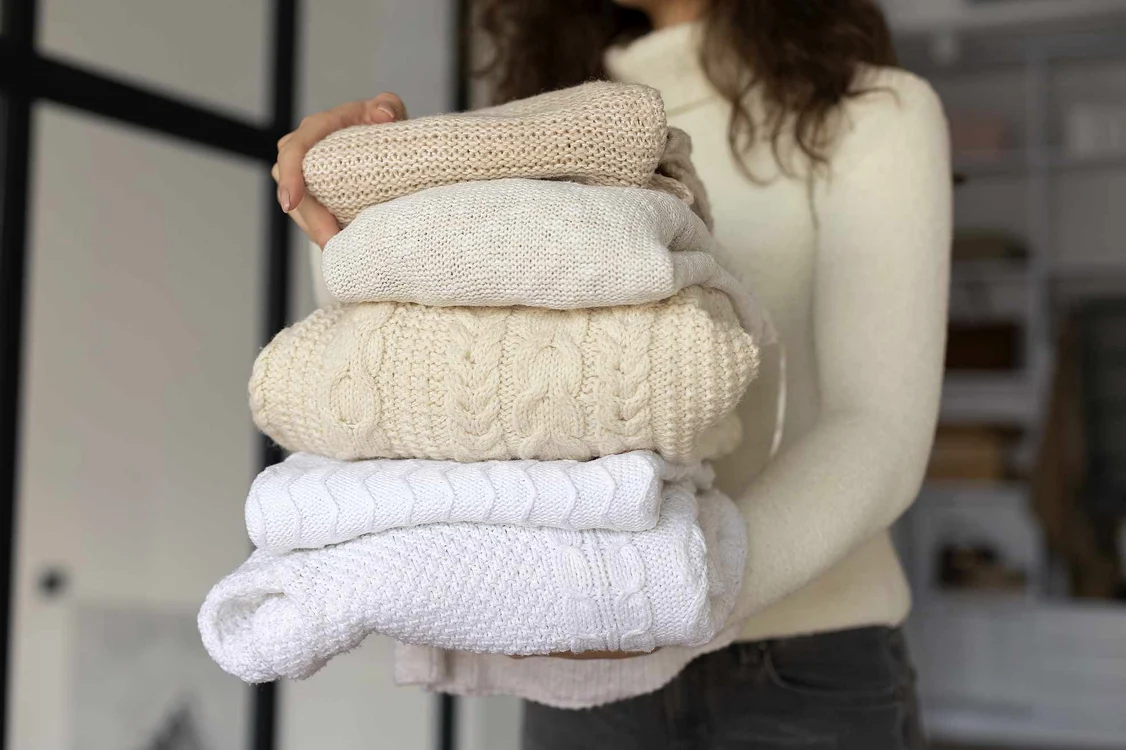 close up woman carrying clothes jpg