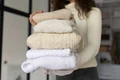close up woman carrying clothes jpg