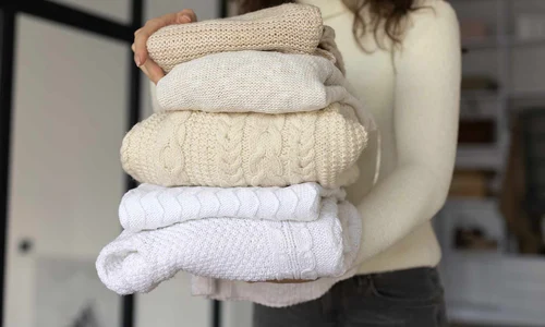 close up woman carrying clothes jpg