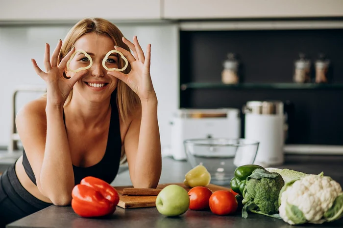young sporty woman with pepper kitchen jpg