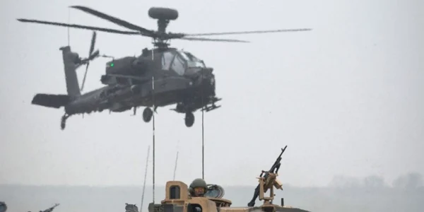 Elicoptere Apache zboară deasupra unei coloane de vehicule blindate din regimentul  Yorks and Kings Royal Hussars care iau parte la  Exercise Tractable în  Salisbury Anglia FOTO Guliver/Getty Images