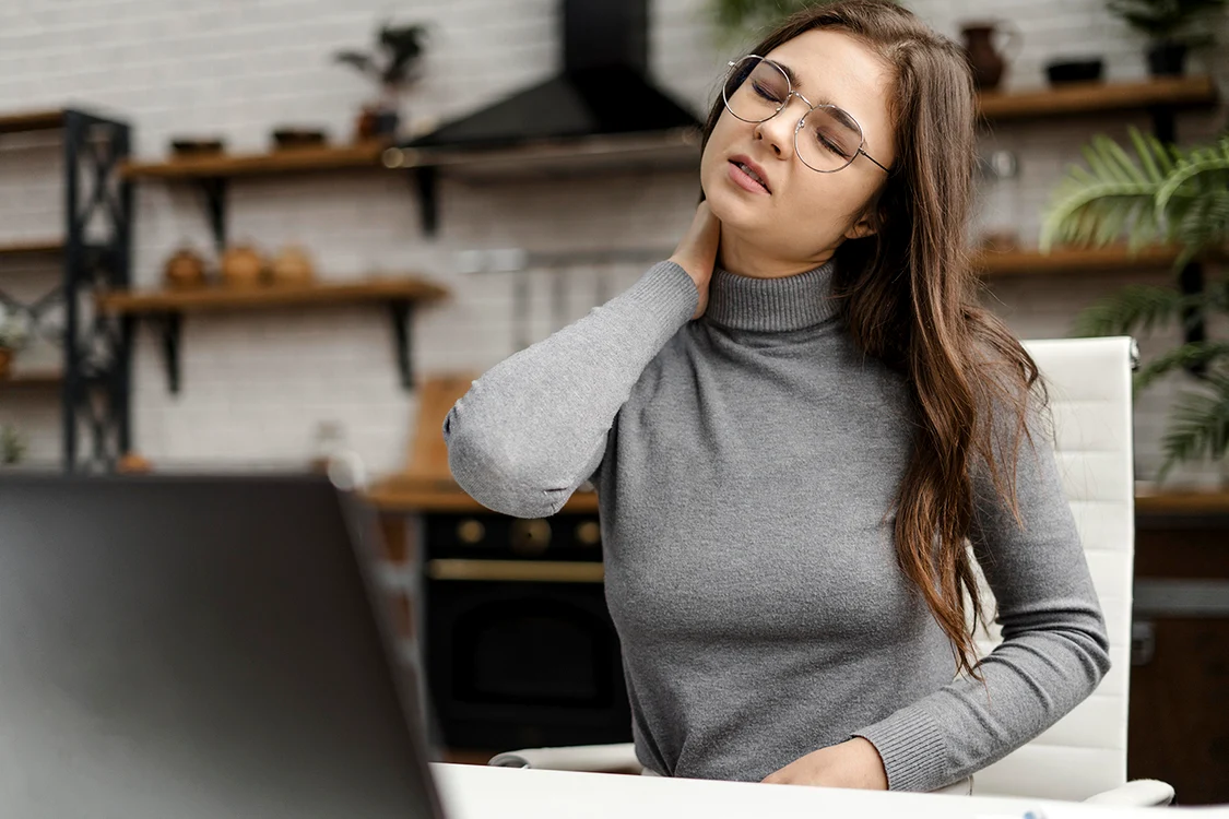 young woman having neckache while working from home copy jpg
