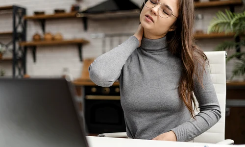 young woman having neckache while working from home copy jpg