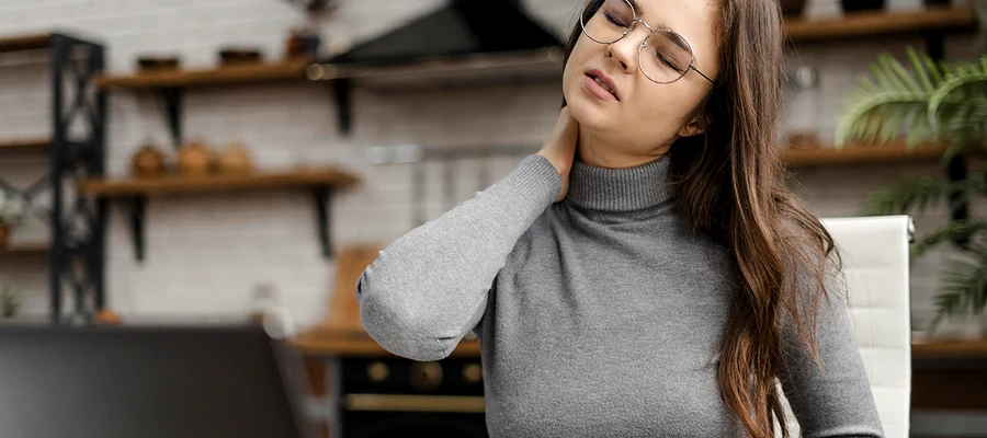 young woman having neckache while working from home copy jpg