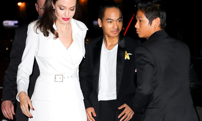Angelina Jolie pose with Maddox and Pax while they where arriving at the after party in New York City jpeg