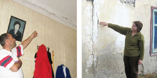 Gigel Dobrea (stânga) şi Florica Paveliuc arată cum le-au crăpat pereţii din cauza traficului greu