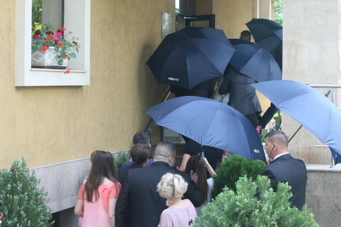Agenții de pază au deschis și umbrele imense, pentru ca însurățeii Florin Pastramă și Brigitte Năstase să nu fie fotografiați