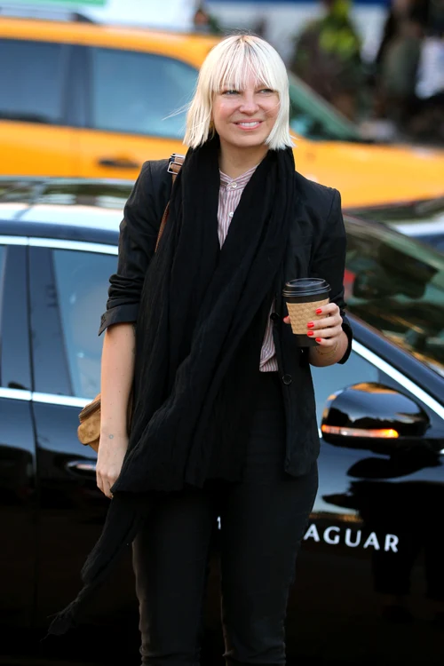 Australian Golden Globe nominated singer Sia Furler, in a very candid moment, tightens the straps of her Manolo Blahnik high heels on Lincoln Center steps before arriving at Metropolitan Opera's Openi jpeg