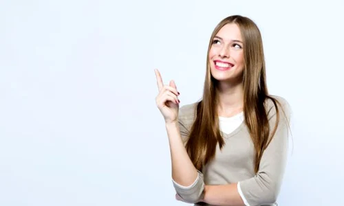 beautiful young woman pointing up over white background 1301 7744 jpeg