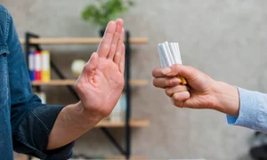 man refusing bunch cigarettes offered by his female friend jpg