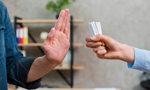 man refusing bunch cigarettes offered by his female friend jpg