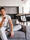 curious couple sitting grey sofa indoor portrait man woman watch tv jpg