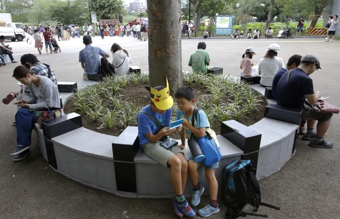 Oamenii joacă Pokemon Go într-un parc din Tokyo. FOTO: AP / Shizuo Kambayashi