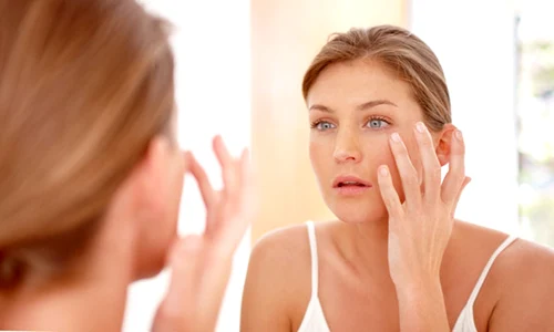 anti aging woman looking at the mirror slimstronghealthy jpeg