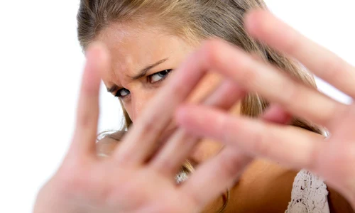 young woman hiding from camera jpg