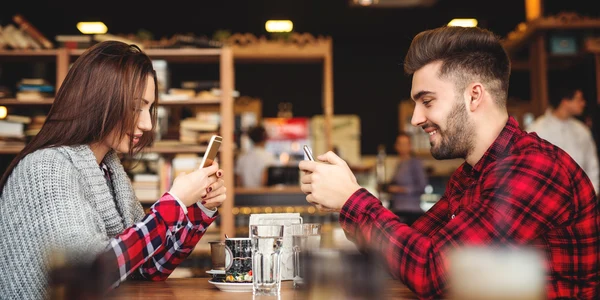 Cuplu la masă scrolează pe smartphone FOTO shutterstock jpg