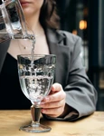 closeup woman pours water into glass cafe jpg