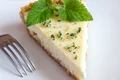 Piece of delicious homemade lemon cheesecake with mint close up jpeg