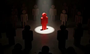 red figure standing out in spotlight surrounded by dark figures in a dim room symbolizing leadership individuality and standing out from the crowd photo jpg