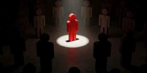 red figure standing out in spotlight surrounded by dark figures in a dim room symbolizing leadership individuality and standing out from the crowd photo jpg