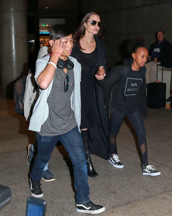 Angelina Jolie & Kids Arriving On A Flight At LAX jpeg