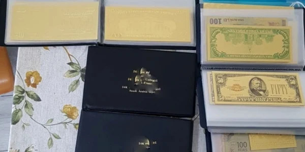 Banii şi alte bunuri confiscate de la hackeri din Vâlcea şi Bistriţa Năsăud în urma unei operaţiuni demarată de Poliţia din Italia Foto DIICOT