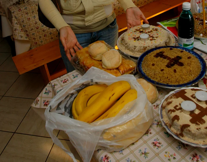 Se sfinţesc la biserică vin, colivă şi prescure, precum şi pachetele de mâncare pregătite pentru a fi împăţite