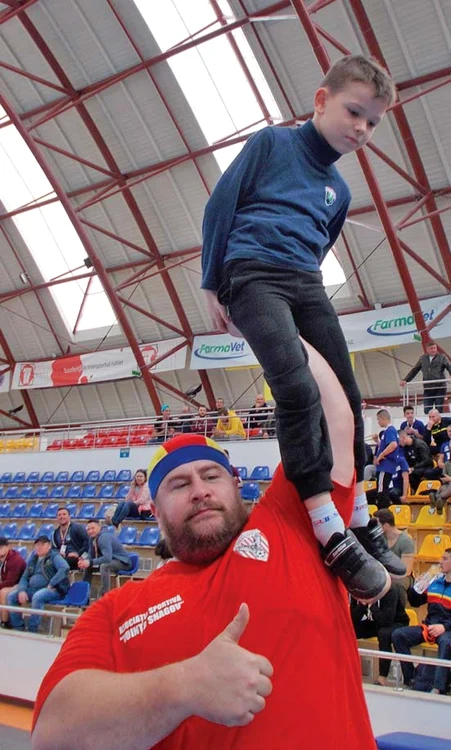 Ridică în palmă  un copil ca şi când  ar fi o jucărie