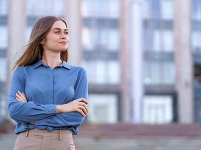 shot beautiful young businesswoman wearing blue chiffon shirt while standing building street with folded arms jpg