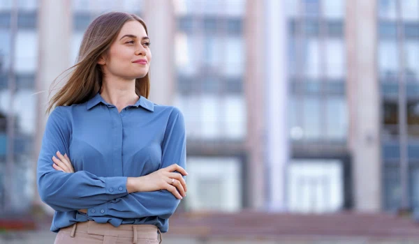 shot beautiful young businesswoman wearing blue chiffon shirt while standing building street with folded arms jpg